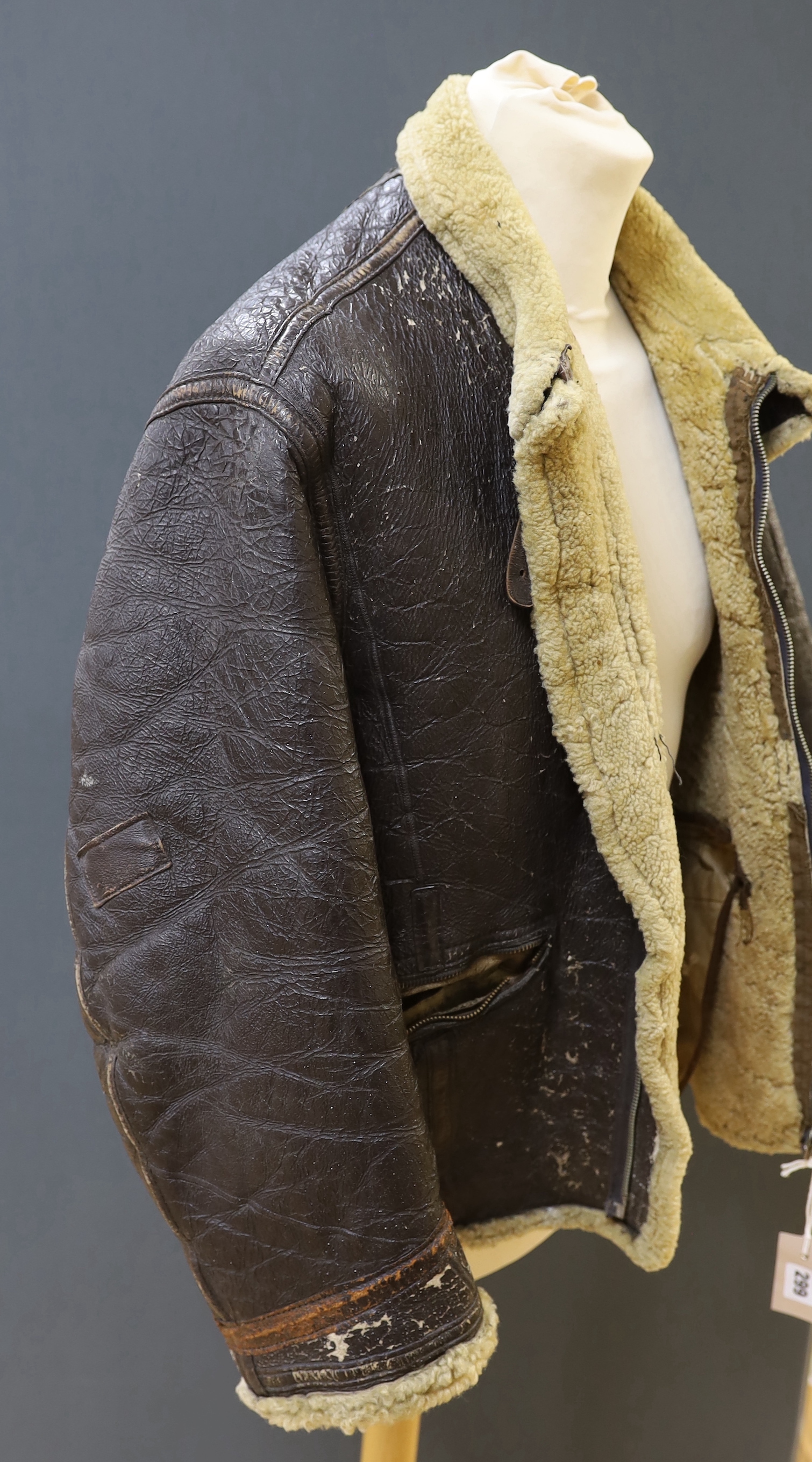 An American US Air Force sheepskin flying jacket, with applied label in collar reading ‘TYPE ….. SIZE MEDIUM SPEC NO. 94-3084 ORDER NO 42-12685-P PROPERTY AIR FORCE U.S. ARMY H. BERNSTEIN & CO.’